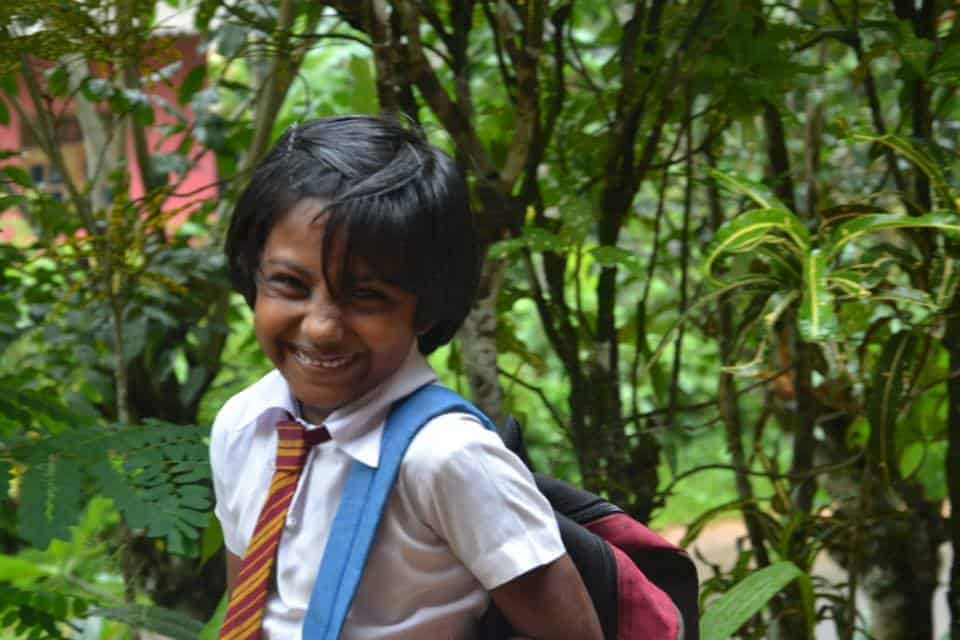 School smily girl with her school bag