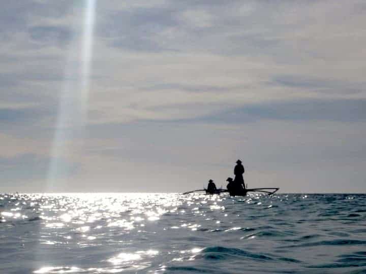 3 People are fishing in Camiguin Island