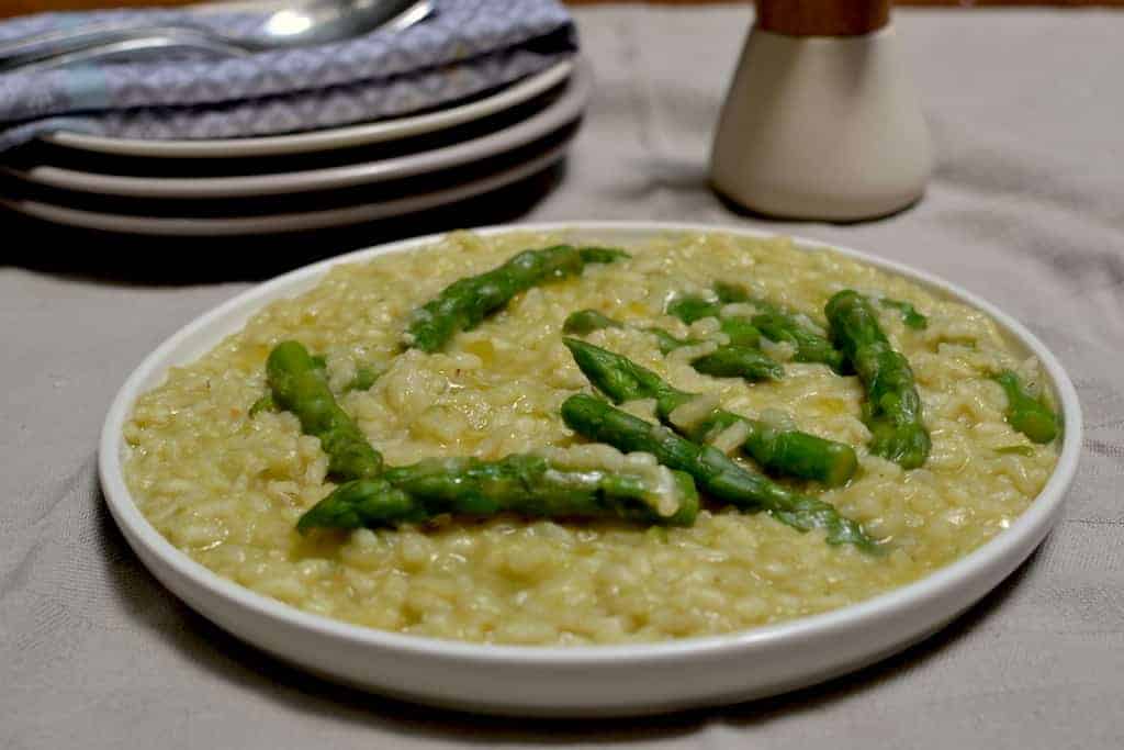 Asparagus risotto in a white plate - Vegan Risotto