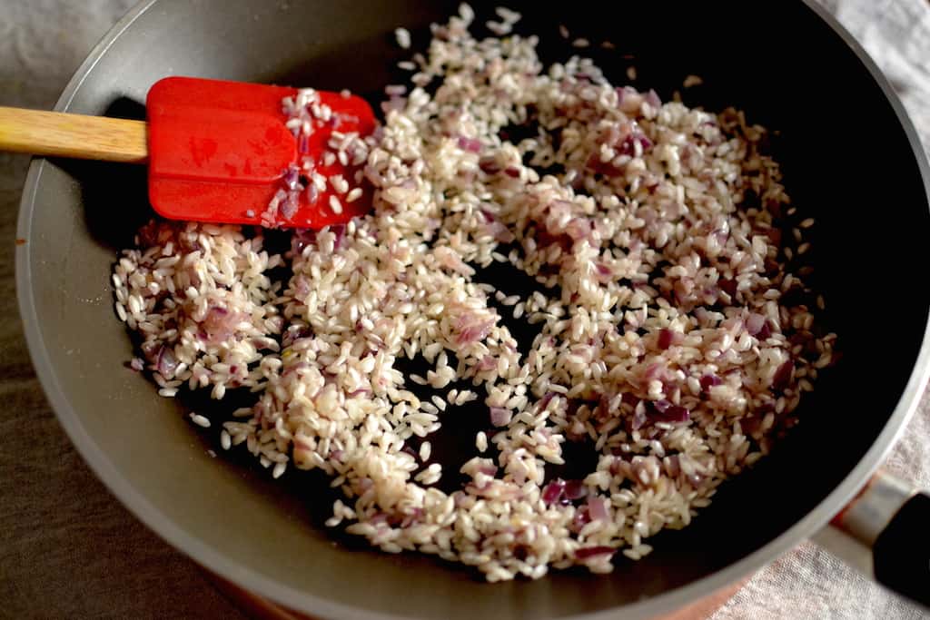 Risotto with onions and garlic in a pan