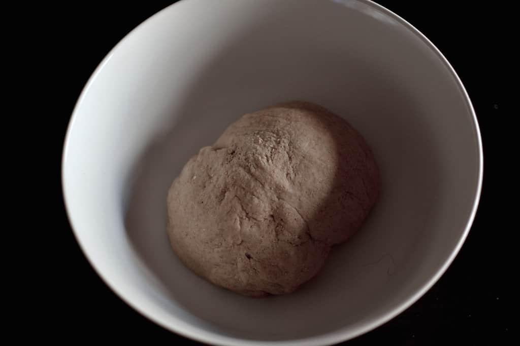 Greek Pita dough in a white bowl