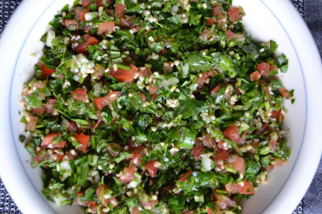 A white plate with Tabouleh salad