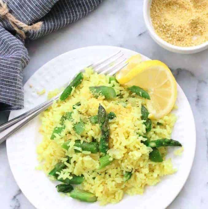 Easy Lemon Rice with Asparagus with lemon and a fork - - Vegan Easter Recipes