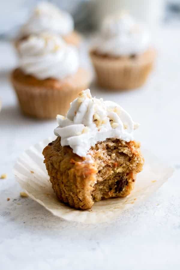 a carrot cupcake with coconut whipped cream