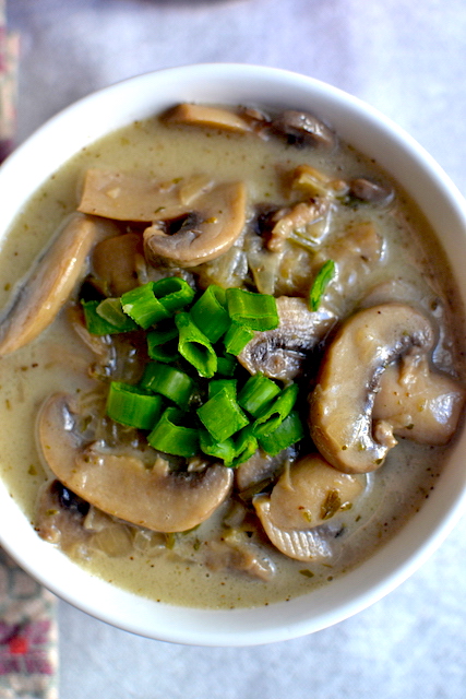 a plate of mushroom soup with chives