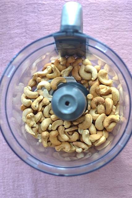 baked cashews in a food processor