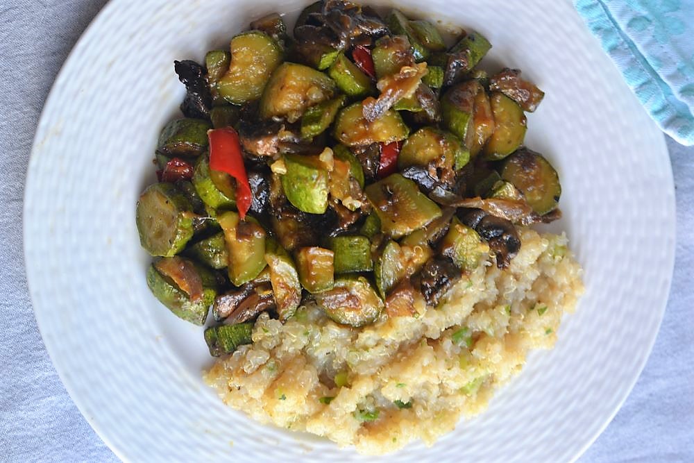 quinoa with veggies in a white plate