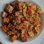 Tofu with cauliflower rice in a white plate